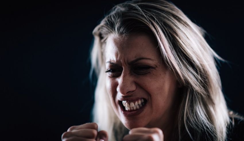 A woman with her fists clenched.