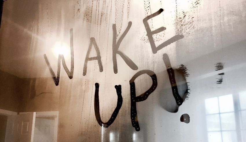 The word wake up is written on a glass door.