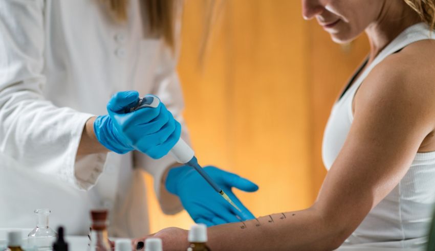 A woman is getting a tattoo with a needle.