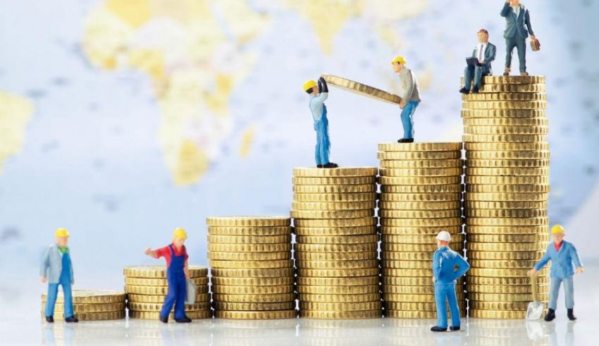 A group of figurines standing on top of stacks of coins.