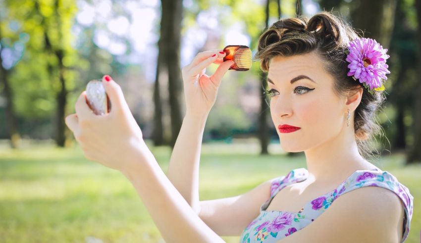 A woman with a flower in her hair is holding a phone in her hand.