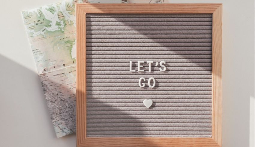 Let's go sign on a wooden board with a map.
