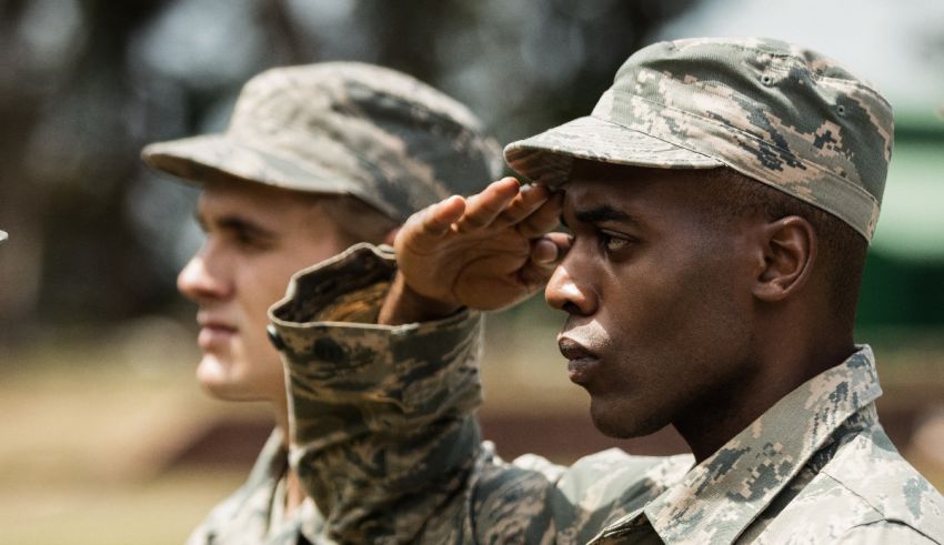 Two air force men saluting each other.