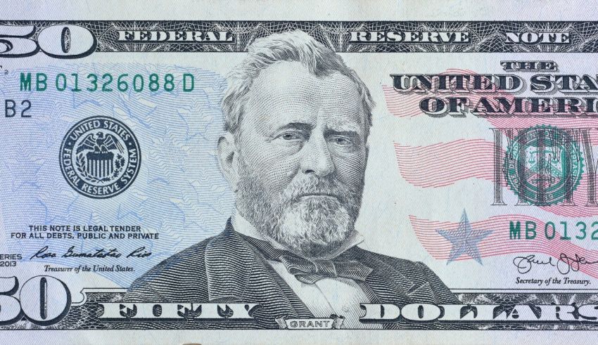 A 50 dollar bill with an american flag on it.
