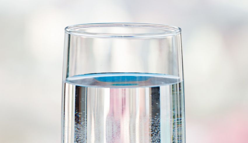 A glass with water in it.