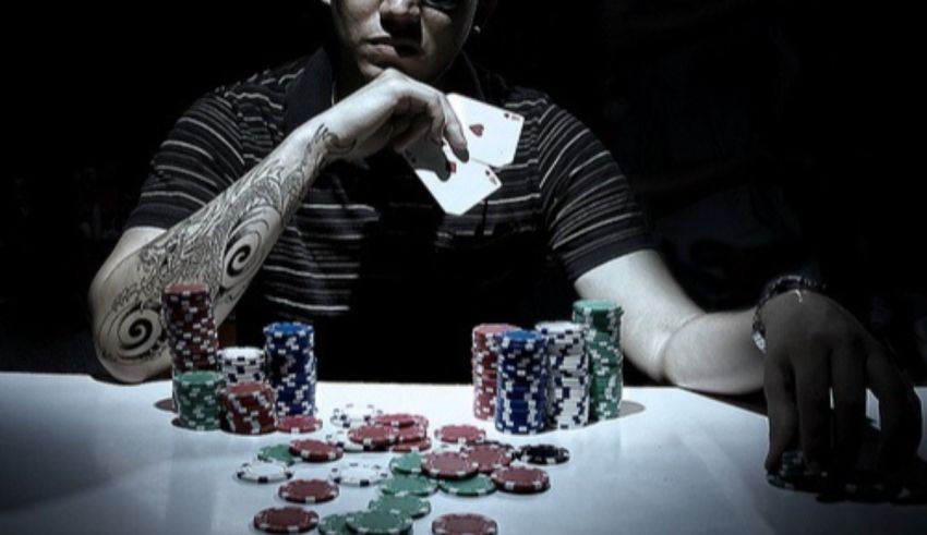 A man sitting at a table with poker chips.