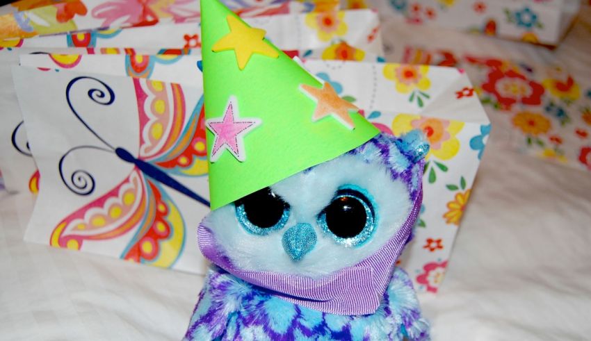 A stuffed owl wearing a party hat.
