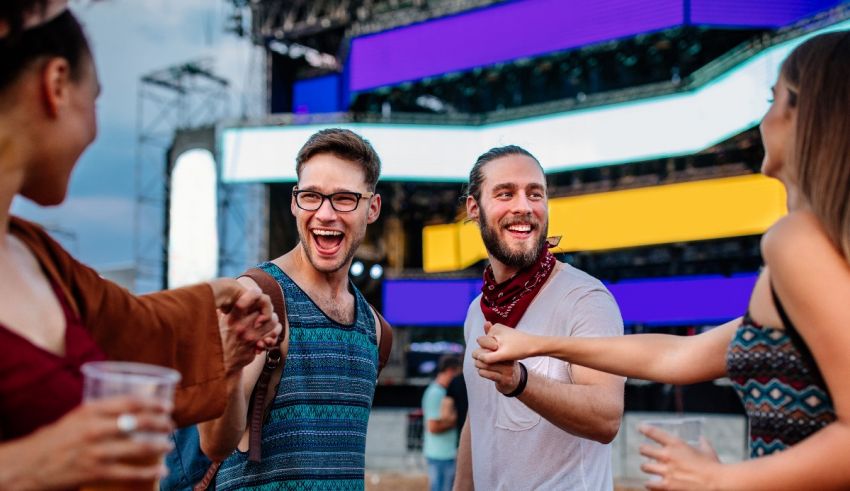 A group of people laughing at a music festival.