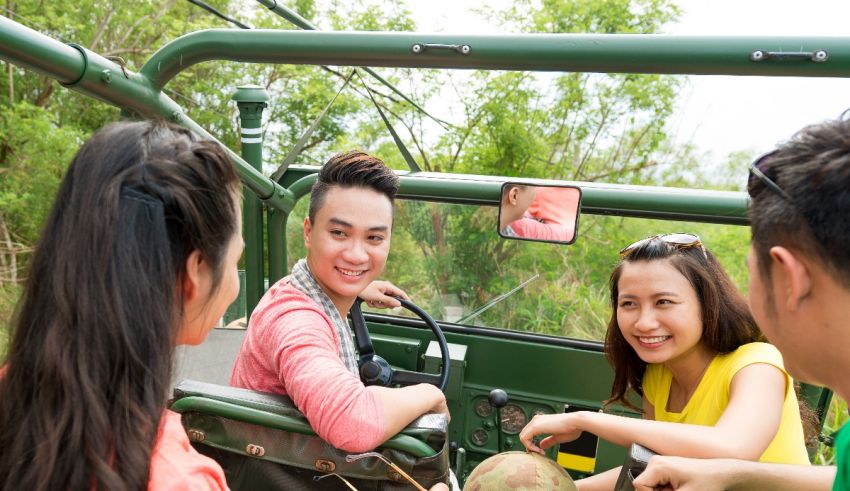 A group of people sitting in a green jeep.