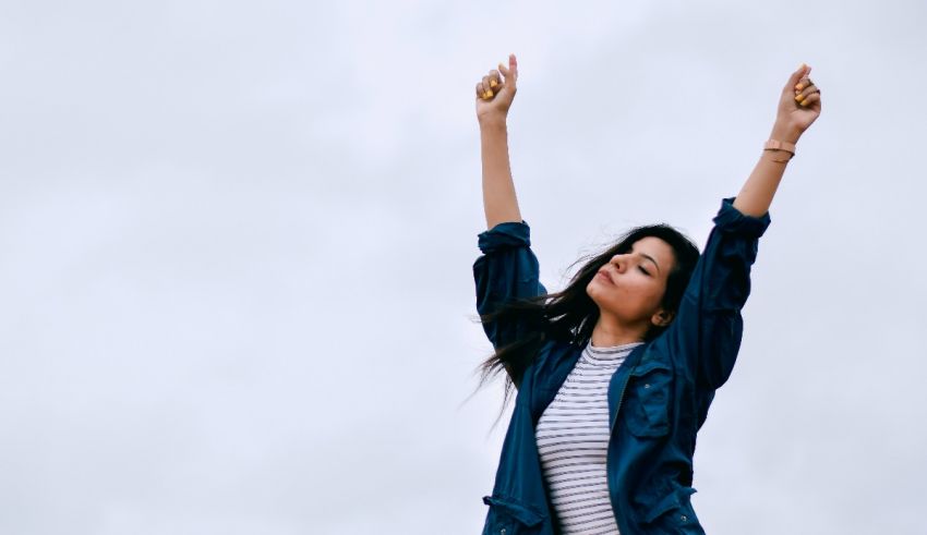 A woman with her arms up in the air.
