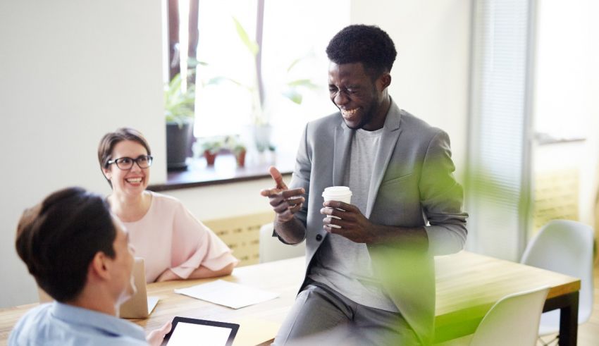 A group of people sitting at a table in an office.