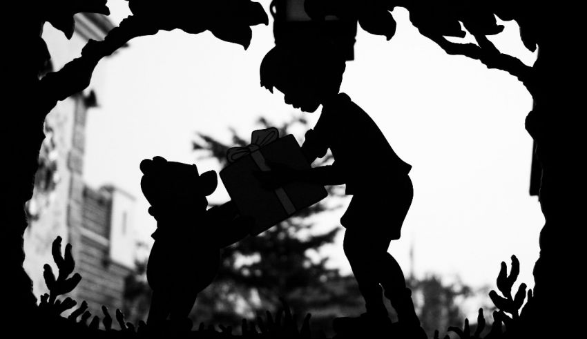 A silhouette of a boy and a teddy bear.