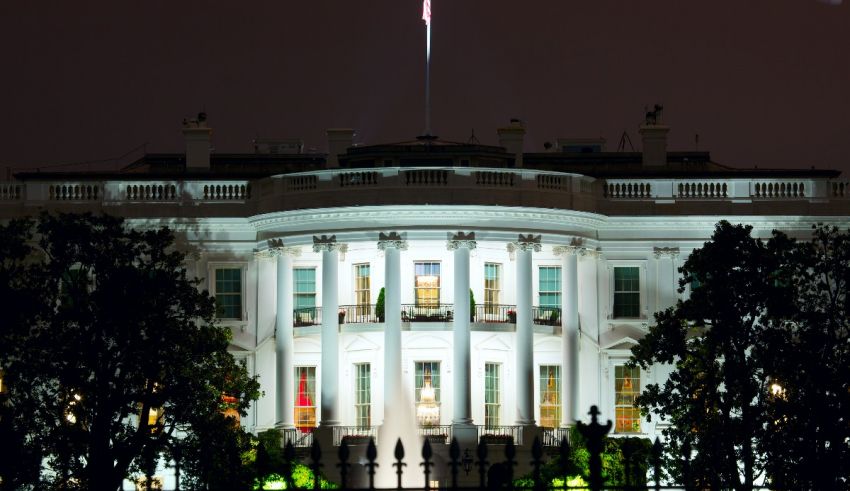 The white house is lit up at night.