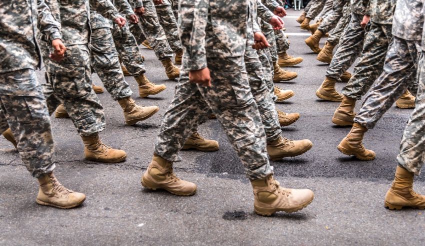 A group of soldiers walking down the street.