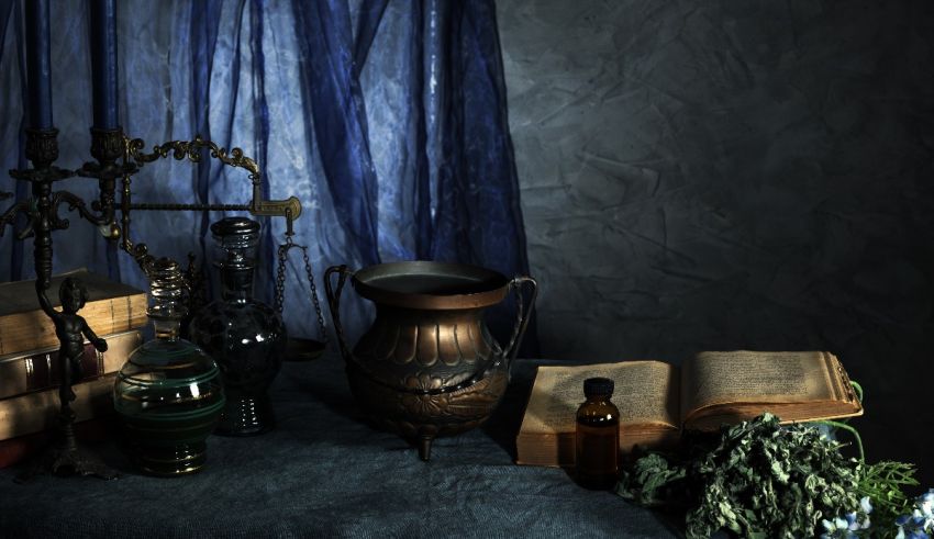 A table with a vase, books, and herbs.