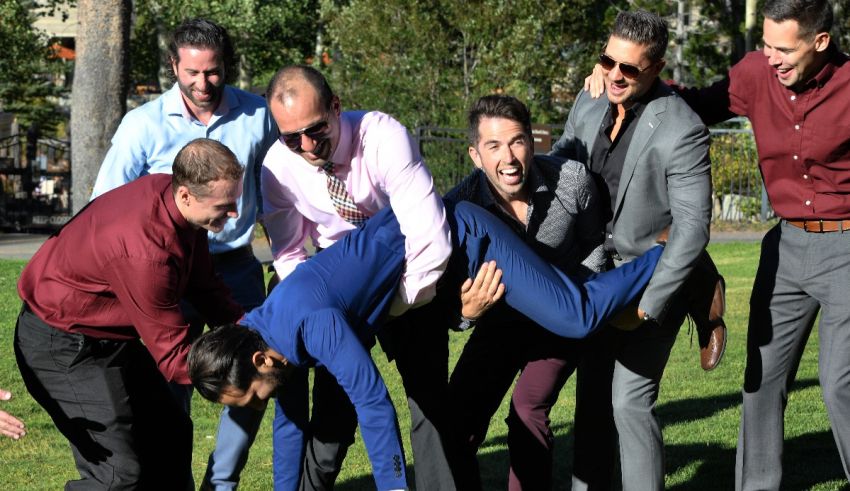 A group of men posing for a picture in a park.