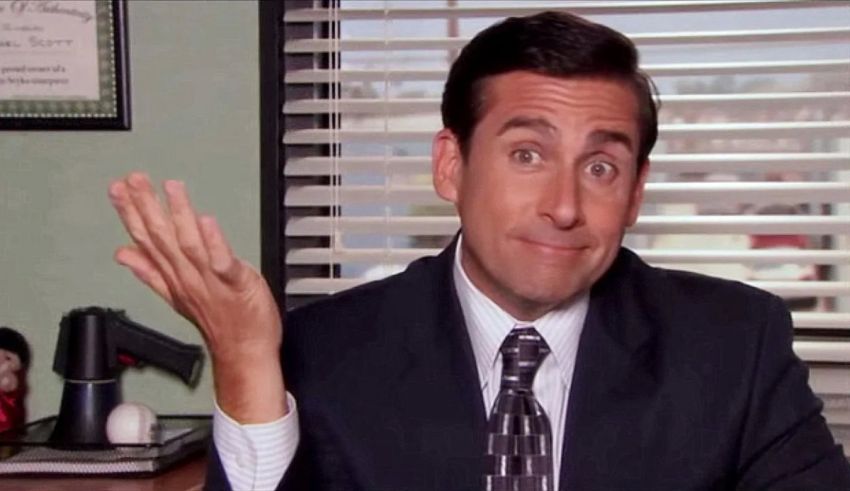 A man in a suit and tie is making a gesture.