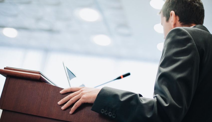 A man is giving a speech at a podium.