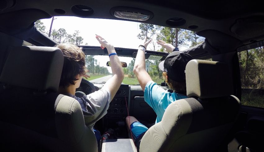 Two people sitting in the back seat of a car.