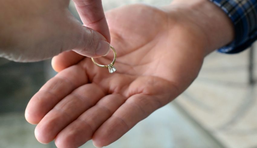 A person is holding a ring in their hand.