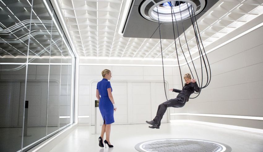 A woman is sitting on a swing in a room.