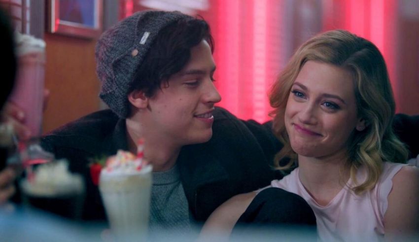 A man and a woman sitting at a table in a diner.