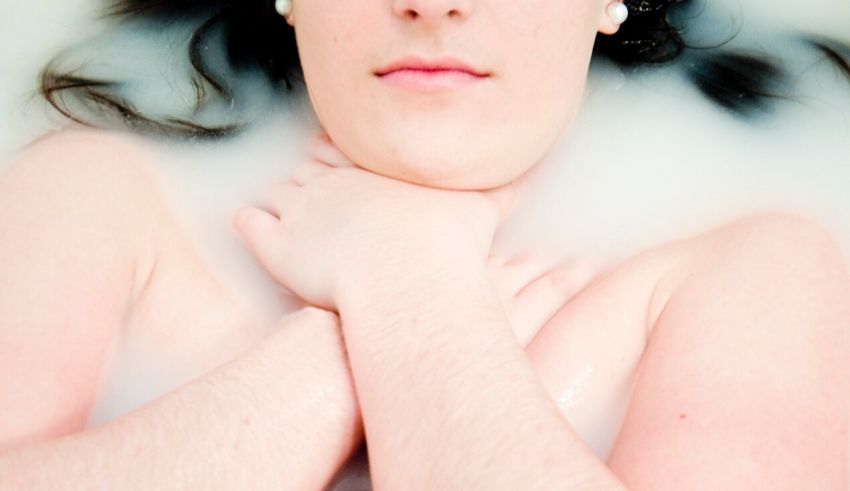 A woman in a bath with a lot of bubbles.
