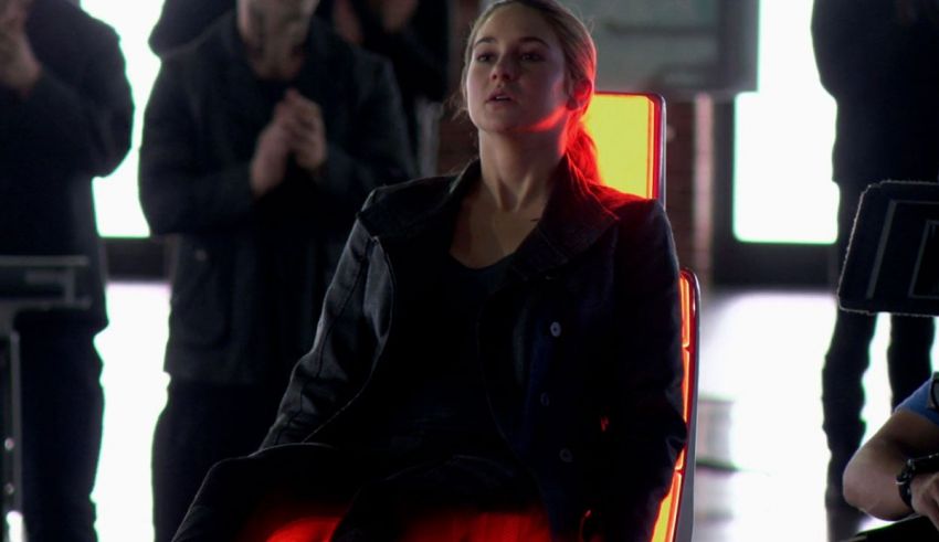 A woman sitting on a chair with a red light behind her.