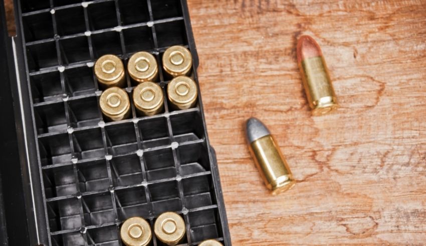 Bullets in a box on a wooden table.