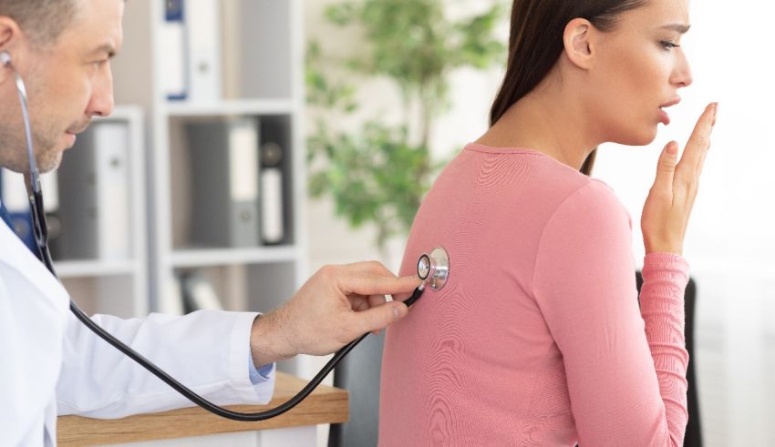A woman is being examined by a doctor with a stethoscope.
