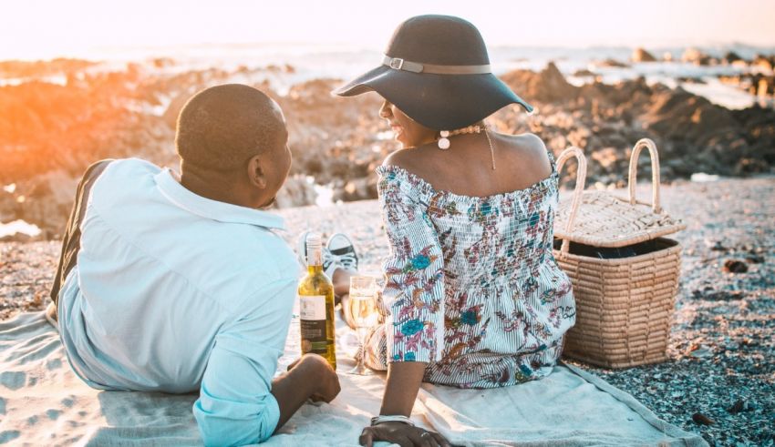 A couple enjoying a picnic on the beach.