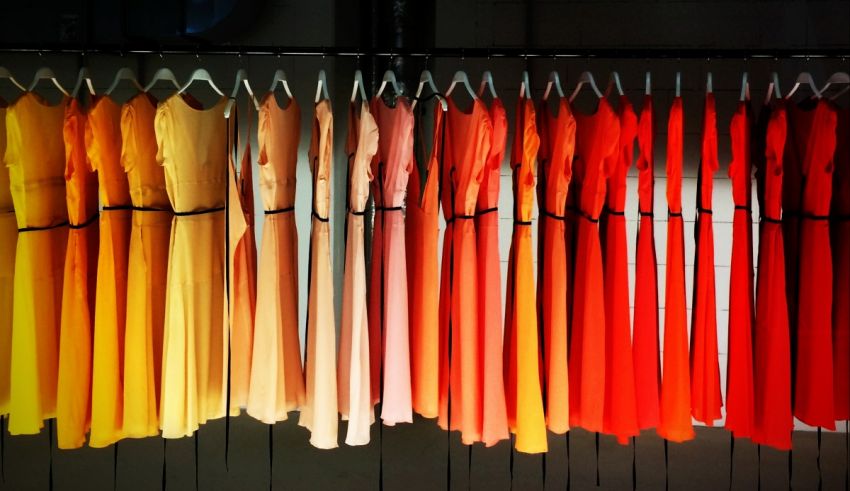 A row of colorful dresses hanging on a rack.