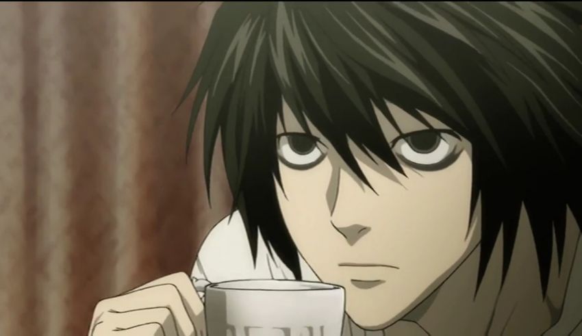 A man with black hair holding a cup of coffee.