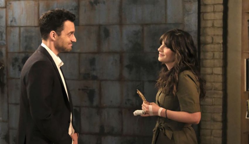 A man and woman talking in front of a brick wall.