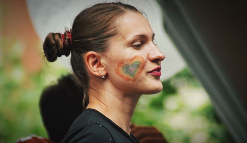 A woman with a heart painted on her face.