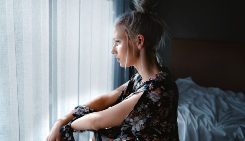 A young woman looking out of a window.