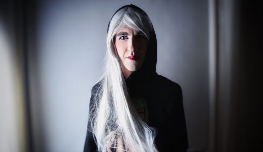 A woman with long white hair wearing a hoodie.