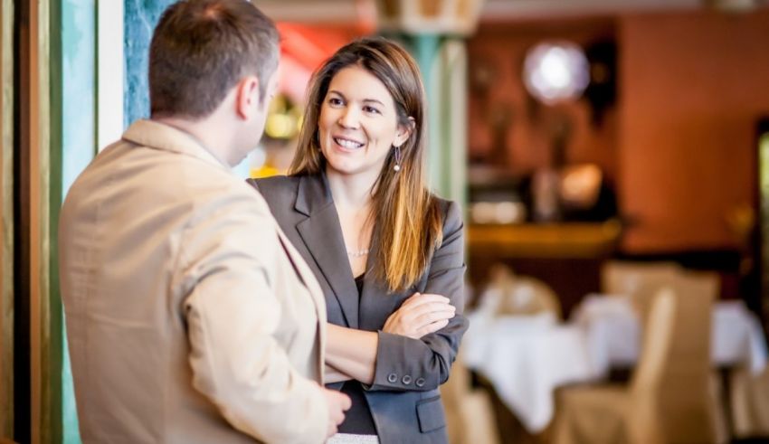 Two business people talking in a restaurant.