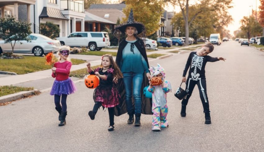 A family dressed up in halloween costumes walking down a street.