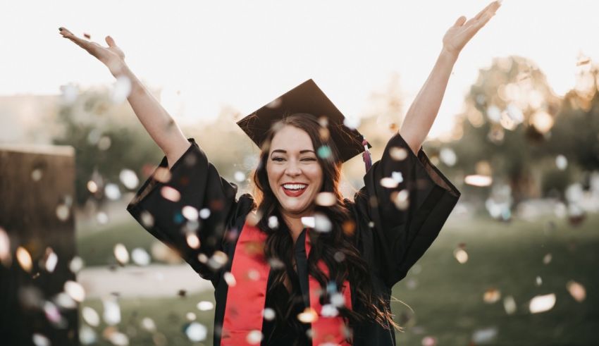 A young woman celebrating her graduation with confetti.