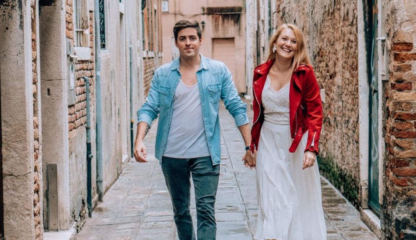 A couple walking down an alleyway in venice, italy.