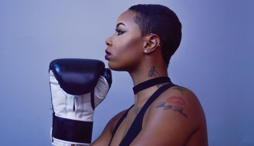 A woman with tattoos and a boxing glove.
