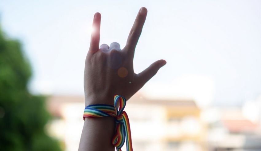 A hand with a rainbow ribbon on it.