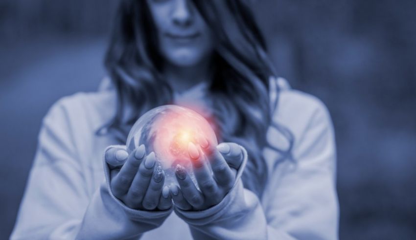 A woman holding a crystal ball in her hands.