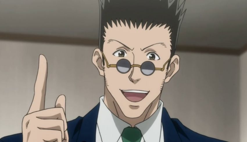 A man in a suit and tie is pointing his finger.