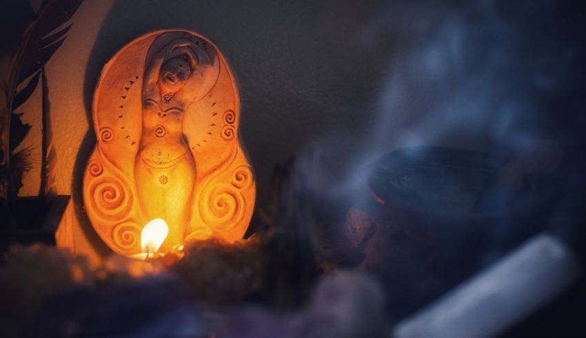 A statue of a woman with a candle in front of it.