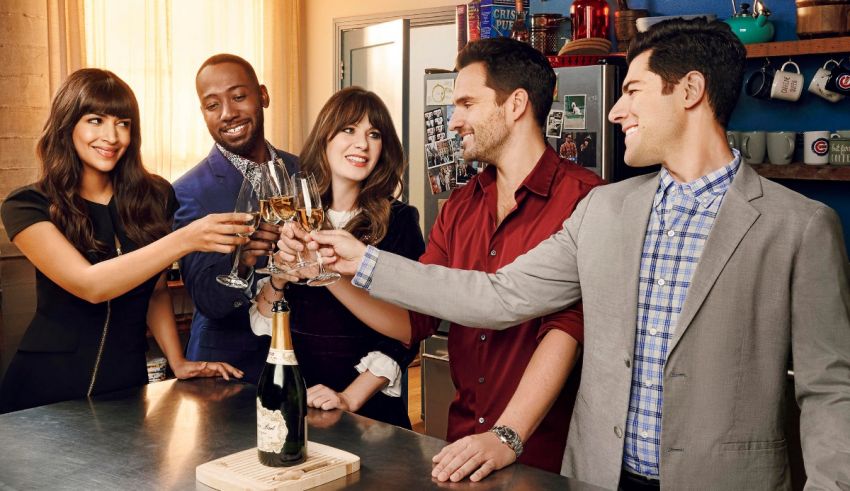 A group of people toasting champagne in a kitchen.