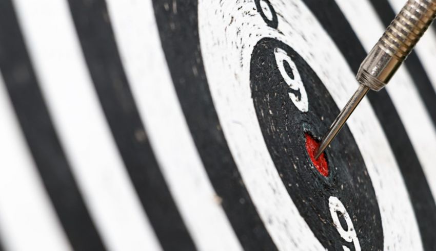 A dart is hitting the center of a target.