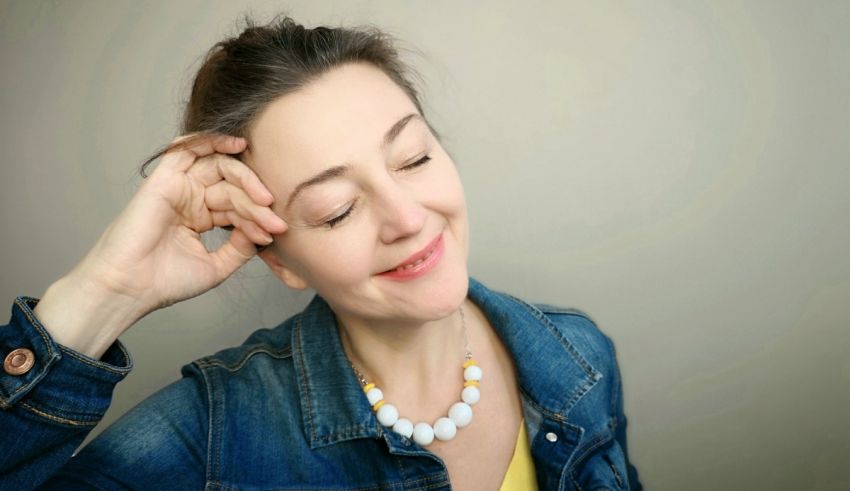 A woman with her hands on her head.