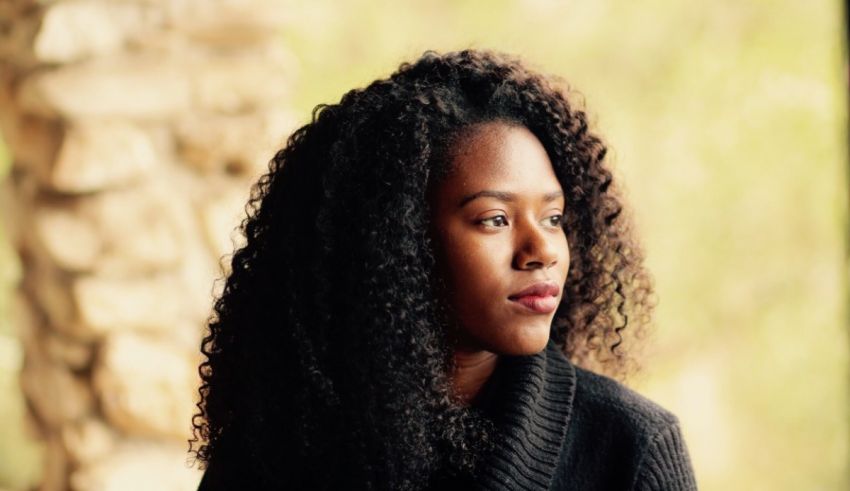 A young black woman with curly hair.